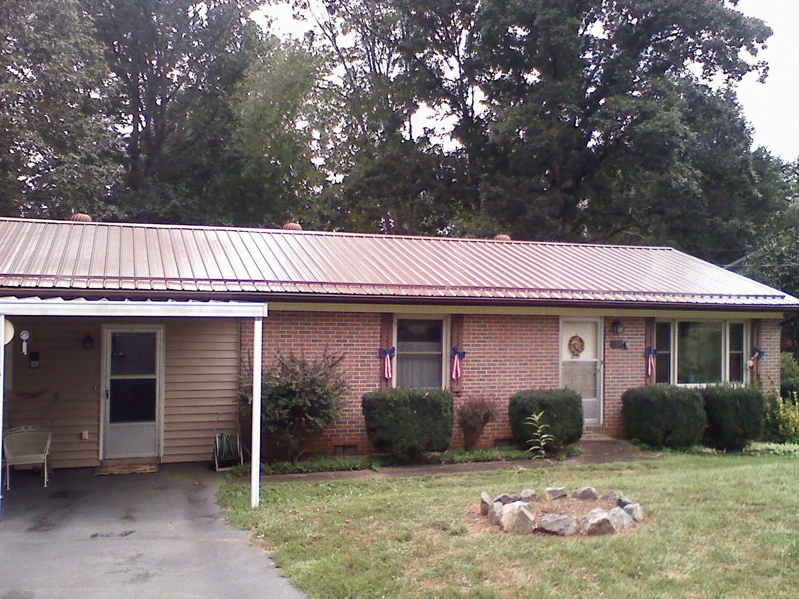 Bronze metal roof and carport on a brick ranch home — Roof Repair work by our crew in East Windsor